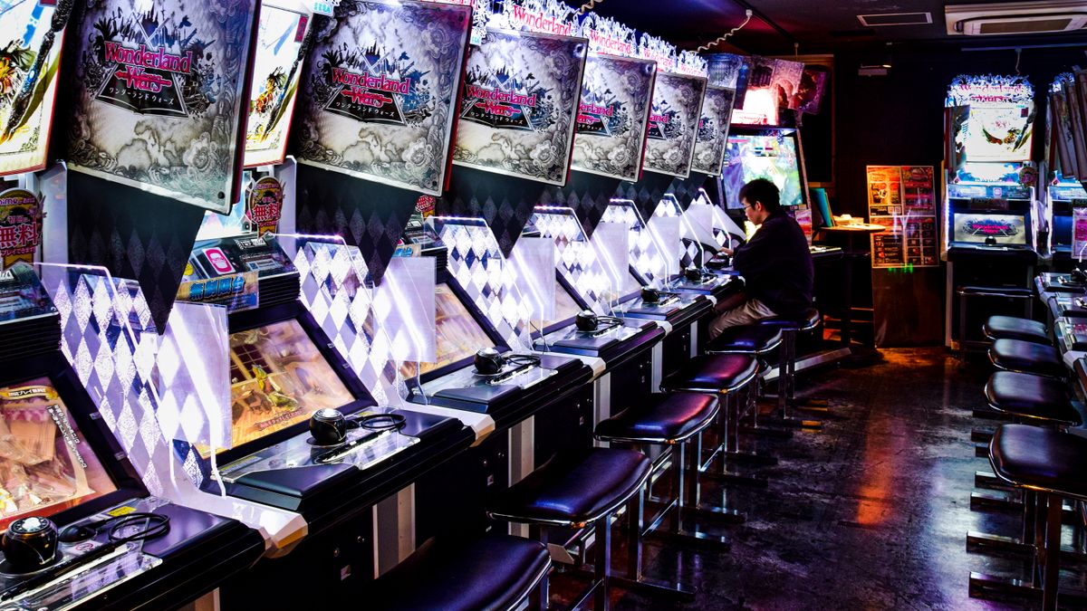 AXP Photography / Pexels A man plays inside a modern arcade in Tokyo, illuminated by neon lights and gaming machines.