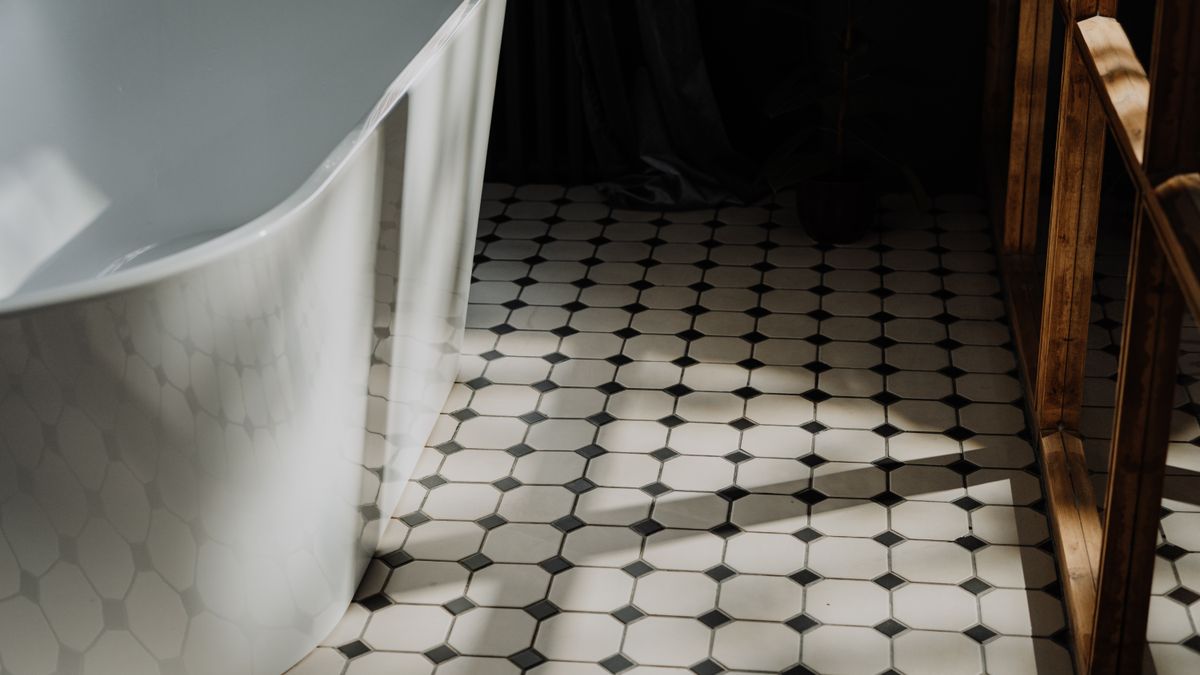 cottonbro studio / Pexels Minimalist bathroom with a freestanding tub and stylish hexagonal floor tiles, showcasing modern design.