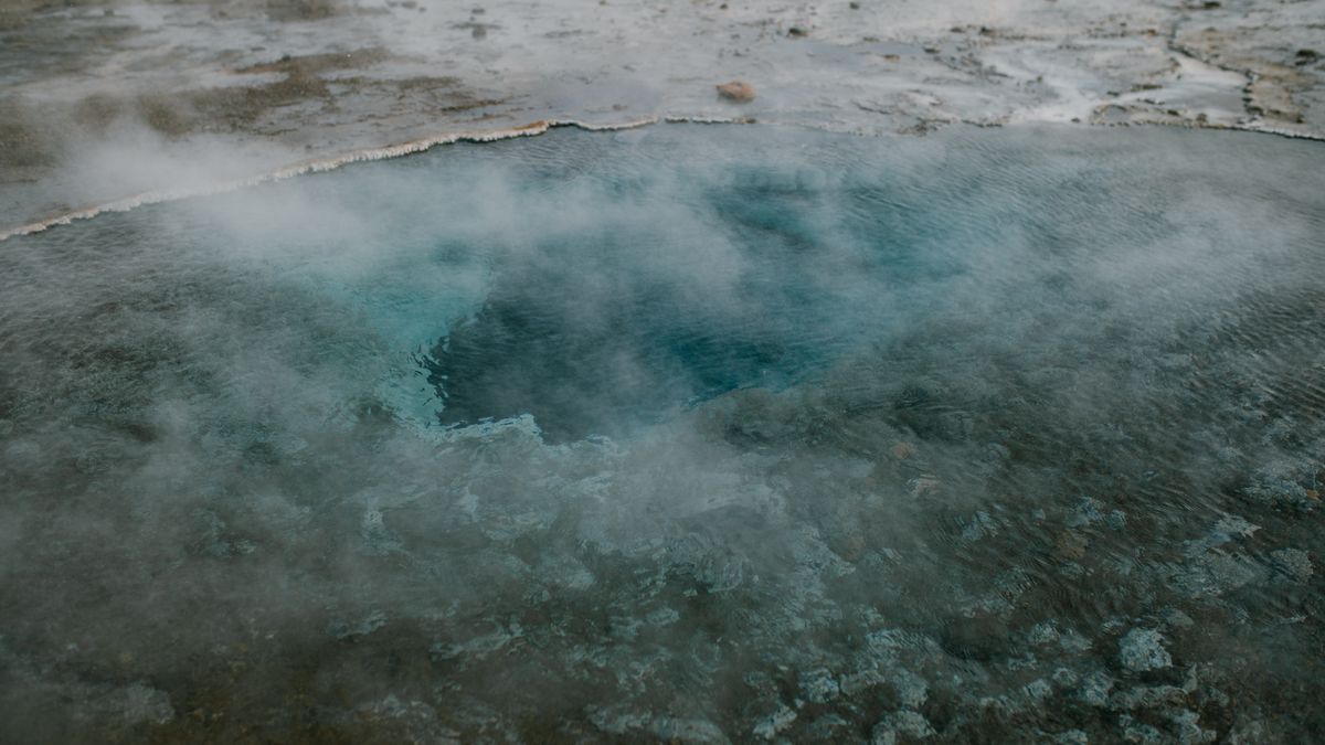 A mesmerizing view of a steaming geyser in Iceland, showcasing nature's geothermal beauty.