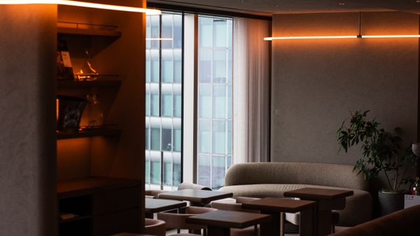 Stylish modern lounge interior with ambient warm lighting and sleek furniture in Tokyo.