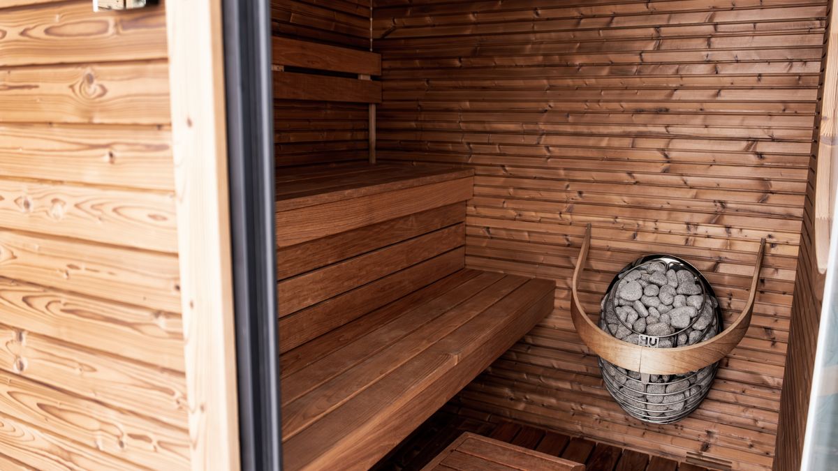 HUUM │sauna heaters / Pexels Explore a serene wooden sauna featuring Nordic design and modern electric heater for ultimate relaxation.