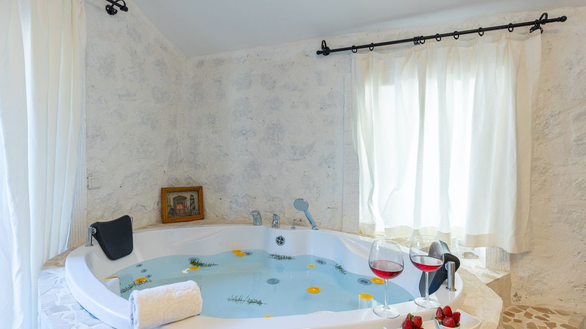 Enjoy relaxation in a luxury jacuzzi bath with wine and strawberries.