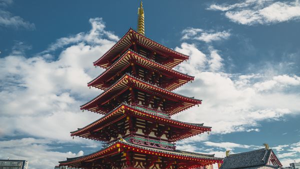 Capture the beauty of the iconic Shitennoji Temple pagoda set against a vibrant blue sky in Osaka, Japan.