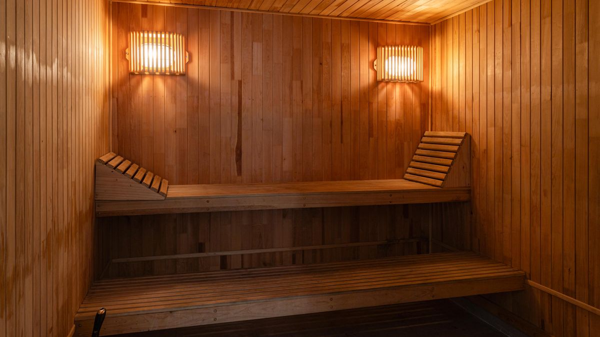 Gustavo Galeano Maz / Pexels A warm, inviting wooden sauna interior with soft lighting for a relaxing spa experience.