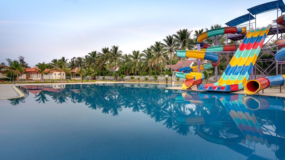 Colorful water slides and a serene pool at a summer water park for relaxation and fun.