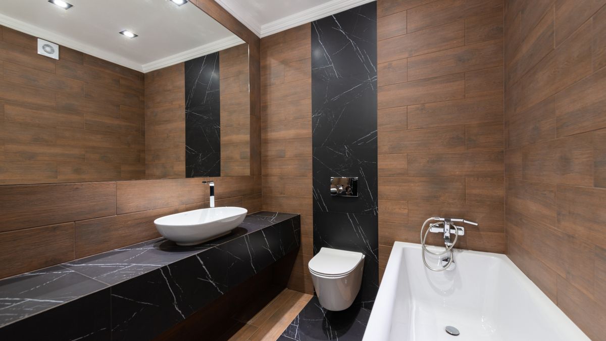 Max Vakhtbovych / Pexels Modern bathroom with wooden accents, sleek fixtures, and minimalist design.